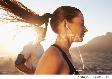 Sunrise, streaming and woman running as exercise or morning workout for health and wellness together. Sport, man and runner run with athlete while training and listening to sports music for energy 133042015