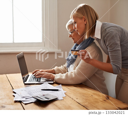 Senior mother, daughter and help with bills or taxes or calculator and debit card or table for savings and accounting at home. Finance, tax and pension or elderly woman or credit payment and pc Senior mother, daughter and help with bills or taxes or calculator and debit card or table for savings and accounting at home. Finance, tax and pension or elderly woman or credit payment and pc 133042021