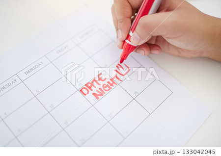 Hands, writing and calendar planning date for schedule, commitment or organized reminder on paper. Hand of person with red marker to write plan, time or day for operation, goals or monthly planner Hands, writing and calendar planning date for schedule, commitment or organized reminder on paper. Hand of person with red marker to write plan, time or day for operation, goals or monthly planner 133042045