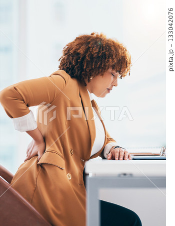 Back pain, injury and black woman in office at desk with spine problem, backache and muscle tension. Stress, medical emergency and female worker massage body for accident, joint strain and pressure Back pain, injury and black woman in office at desk with spine problem, backache and muscle tension. Stress, medical emergency and female worker massage body for accident, joint strain and pressure 133042076