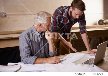 Architecture, collaboration and father and son with blueprint in workshop for building construction on laptop. Senior engineer, men and paperwork of trainee or apprentice working on design and plan. Architecture, collaboration and father and son with blueprint in workshop for building construction on laptop. Senior engineer, men and paperwork of trainee or apprentice working on design and plan. 133042215