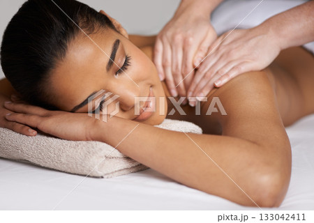 Woman, eyes closed or hands for back massage in hotel to relax for zen resting or wellness physical therapy. Face of girl in salon spa for body healing, sleeping or natural holistic detox by masseuse Woman, eyes closed or hands for back massage in hotel to relax for zen resting or wellness physical therapy. Face of girl in salon spa for body healing, sleeping or natural holistic detox by masseuse 133042411