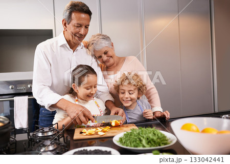 Food, grandparents or happy children learning cooking skills for a healthy dinner with fruit or vegetables at home. Teaching kids, knife or grandmother with old man or diet meal nutrition in kitchen 133042441