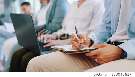 Business people, writing and meeting in workshop, planning or strategy for ideas at office conference. Hands of employee taking notes in presentation, project plan or staff training at workplace 133042617