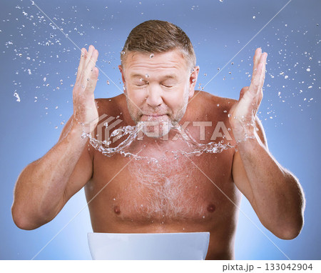 Man cleaning face, skincare and water drops, hygiene and grooming with clean facial on blue background. Mature man washing skin, basin and hands with natural cosmetic care, wellness and dermatology Man cleaning face, skincare and water drops, hygiene and grooming with clean facial on blue background. Mature man washing skin, basin and hands with natural cosmetic care, wellness and dermatology 133042904