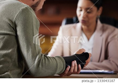 Hand injury, compensation and lawyer people with insurance, legal advice and contract meeting. Disability, accident and person in lawyer or attorney consultant for advice, agreement or policy report Hand injury, compensation and lawyer people with insurance, legal advice and contract meeting. Disability, accident and person in lawyer or attorney consultant for advice, agreement or policy report 133043187
