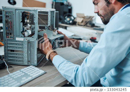 Engineering, technician and man fixing the hardware of a computer in workshop or office. IT, technology and male professional doing maintenance or repairs on microcircuit or motherboard in workplace. Engineering, technician and man fixing the hardware of a computer in workshop or office. IT, technology and male professional doing maintenance or repairs on microcircuit or motherboard in workplace. 133043245