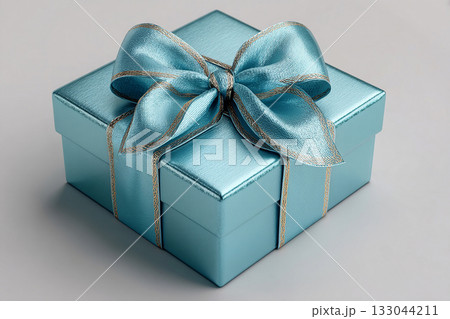 Elegant present. Blue box wrapped with a bow on white background. Jewelry, birthdays, Christmas and luxury branding. Elegant present. Blue box wrapped with a bow on white background. Jewelry, birthdays, Christmas and luxury branding. 133044211
