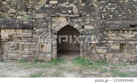 Old Rohtas Fort room with light arch beside wooden gate 133045040