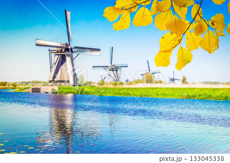 dutch windmill over river waters 133045338