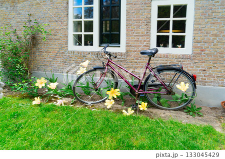 Old bicycle next to canal of Amsterdam Old bicycle next to canal of Amsterdam 133045429