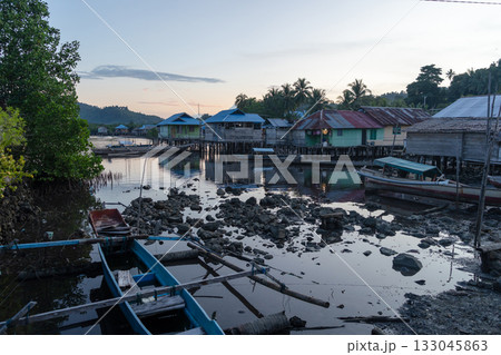 Fishermen village at sunset on Waleakodi Island, Togian archipelago, Indonesia Fishermen village at sunset on Waleakodi Island, Togian archipelago, Indonesia 133045863