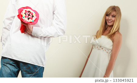 Man giving woman candy bunch flowers. Love. Man giving woman candy bunch flowers. Love. 133045921