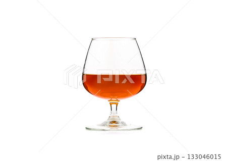 A glass of wine is sitting on a table 133046015