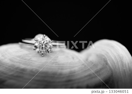 A diamond ring is on a white surface A diamond ring is on a white surface 133046051