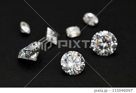 A collection of diamonds and other gemstones are displayed on a black background A collection of diamonds and other gemstones are displayed on a black background 133046097