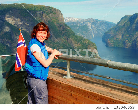 Tourist over Aurlandsfjord with norwegian flag 133046655