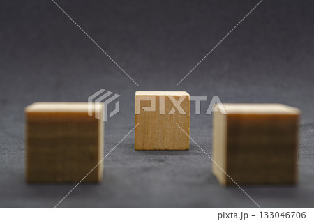 An isolated wooden cube on black cover background with customizable space for text or ideas. Copy space concept An isolated wooden cube on black cover background with customizable space for text or ideas. Copy space concept 133046706