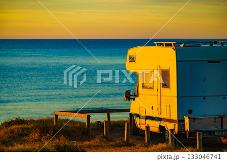 Camper vehicle on beach at sunrise 133046741