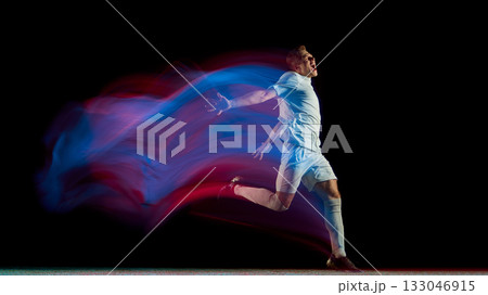 Soccer player running in neon light motion with expressive celebration gesture Soccer player running in neon light motion with expressive celebration gesture 133046915