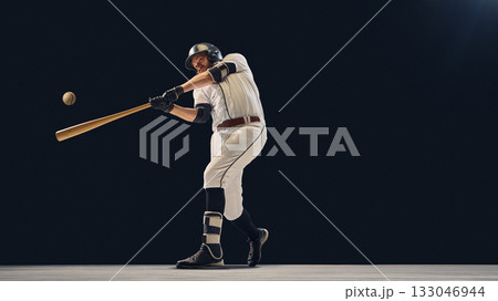 Baseball player making contact with ball demonstrating correct batting alignment 133046944