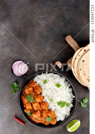 Indian butter chicken with basmati rice, roti or chapatti on gray background. Top view. Copy space. Indian butter chicken with basmati rice, roti or chapatti on gray background. Top view. Copy space. 133047153
