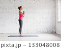 Yoga, start position. Caucasian fit woman in sportswear practice indoor in loft studio. 133048008