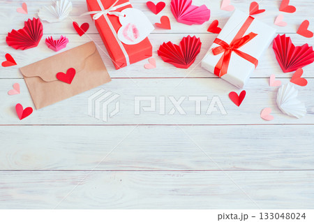 gift boxes and red hearts with a craft envelope on a wooden background, love gift boxes and red hearts with a craft envelope on a wooden background, love 133048024