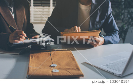 Lawyer explained to the client about the law that must be brought against the court case. Lawyer explained to the client about the law that must be brought against the court case. 133048194