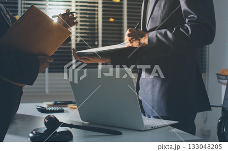 Lawyer explained to the client about the law that must be brought against the court case. Lawyer explained to the client about the law that must be brought against the court case. 133048205