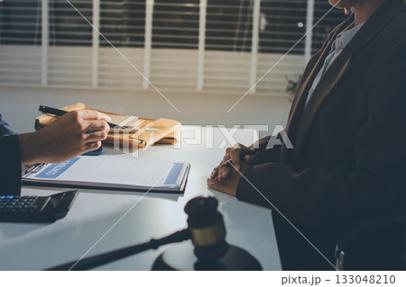 Lawyer explained to the client about the law that must be brought against the court case. Lawyer explained to the client about the law that must be brought against the court case. 133048210