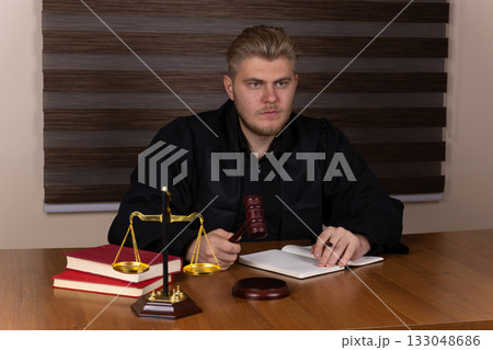 The judge is presiding over a court session, preparing to make a ruling The judge is presiding over a court session, preparing to make a ruling 133048686