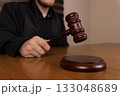 A judge is seen bringing down a gavel onto a sound block 133048689