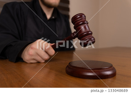 A judge is seen bringing down a gavel onto a sound block A judge is seen bringing down a gavel onto a sound block 133048689