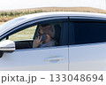 Man is talking on a mobile phone inside a white car 133048694