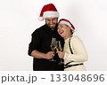 The couple is enjoying hot cocoa while wearing Santa hats for the Christmas  133048696
