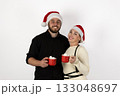 The couple is enjoying hot cocoa while wearing Santa hats for the Christmas 133048697