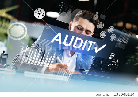 Professional conducting a financial audit with digital tools in a modern office setting 133049114