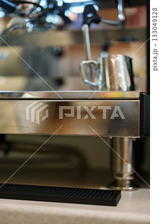 Stainless steel espresso machine prepares coffee at a busy cafe counter in the morning 133049128
