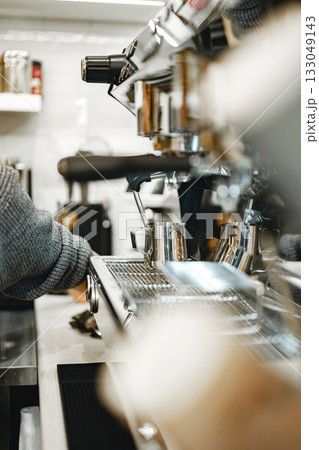 Barista preparing coffee in busy cafe during morning rush in downtown area Barista preparing coffee in busy cafe during morning rush in downtown area 133049143