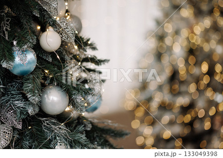 Christmas tree with silver and blue ornaments and fairy lights with copy space Christmas tree with silver and blue ornaments and fairy lights with copy space 133049398
