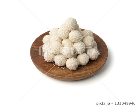 Coconut candies pile, coco ball. White truffle ball, indian ladoo or laddu with sweet cream Coconut candies pile, coco ball. White truffle ball, indian ladoo or laddu with sweet cream 133049946