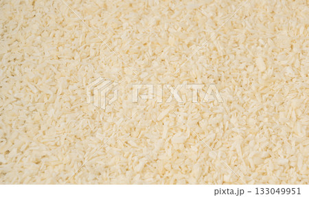 Grated coconut powder. Dry coco flakes pile, shredded desiccated coconut, tropical fruit chips 133049951