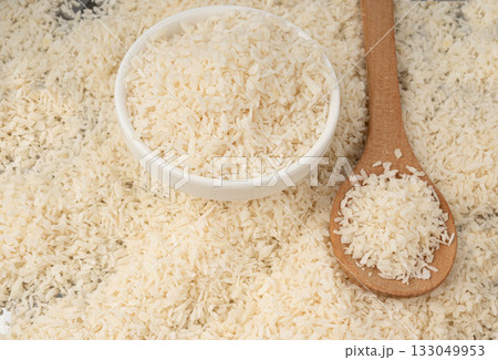Grated coconut powder. Dry coco flakes pile, shredded desiccated coconut, tropical fruit chips Grated coconut powder. Dry coco flakes pile, shredded desiccated coconut, tropical fruit chips 133049953