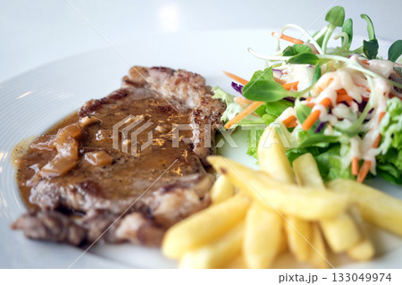 Close up of Grilled beef steak, boiled french fries and vegetable salad;Selective focus Close up of Grilled beef steak, boiled french fries and vegetable salad;Selective focus 133049974