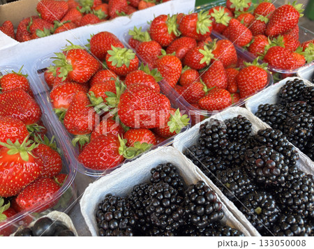 Fruit background with berry mix. Fresh juice blackberries and strawberries in market boxes Fruit background with berry mix. Fresh juice blackberries and strawberries in market boxes 133050008