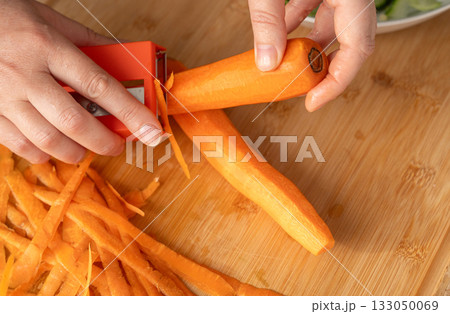 Fresh Carrot Peeling with Knife Close Up, Raw Carrot Slices, Orange Root Vegetable Fresh Carrot Peeling with Knife Close Up, Raw Carrot Slices, Orange Root Vegetable 133050069