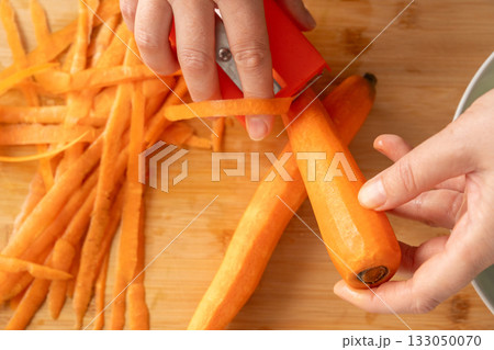 Fresh Carrot Peeling with Knife Close Up, Raw Carrot Slices, Orange Root Vegetable 133050070