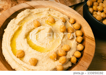 Hummus in bowl, houmous dip, chickpea humus tahini sauce, middle eastern spread Hummus in bowl, houmous dip, chickpea humus tahini sauce, middle eastern spread 133050192