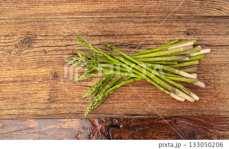 Bunch of Raw Garden Asparagus on Wood Rustic Tabletop. Fresh Green Spring Vegetables Bunch of Raw Garden Asparagus on Wood Rustic Tabletop. Fresh Green Spring Vegetables 133050206